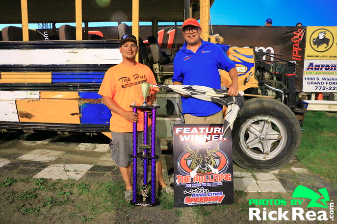 Wes Rosinski holding the trophy being interviewed by John Roberts in RydellCars.com Victory Lane at The World Famous Legendary Bullring River Cities Speedway after his commanding win in the School Bus A Main Feature Race - Photo by Rick Rea